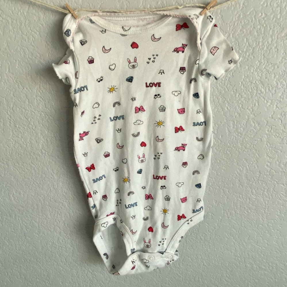 White onesie with small colorful designs